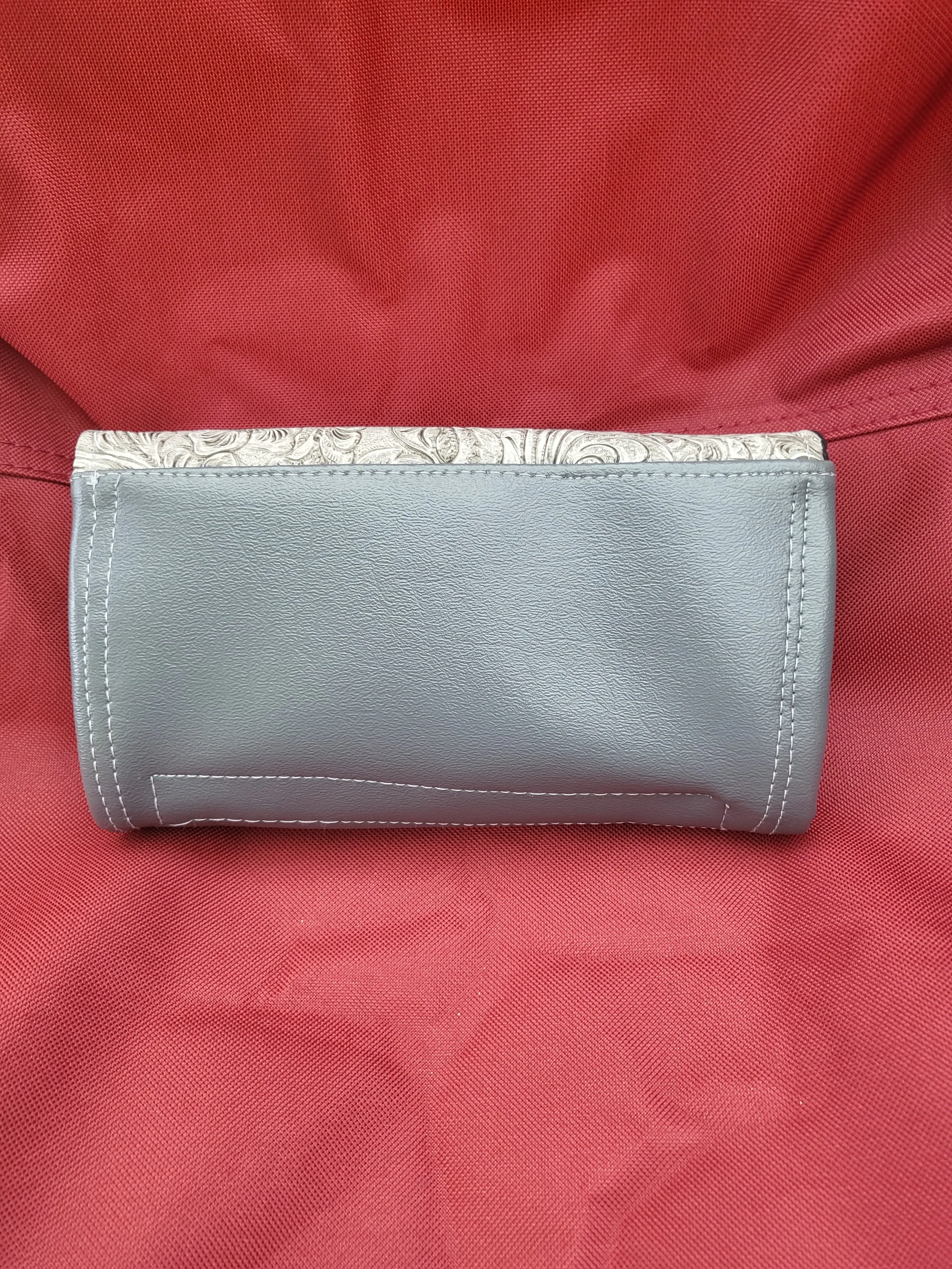 Handmade clutch wallets made with upcycled fabrics - embossed